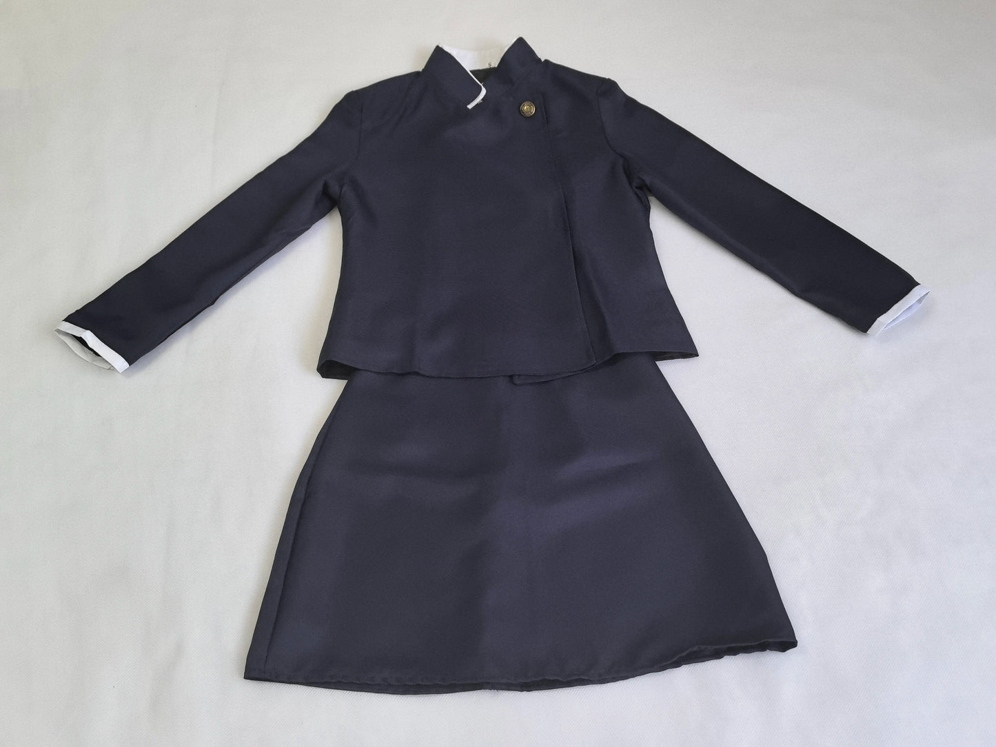 Navy blue two-piece outfit on a light gray background