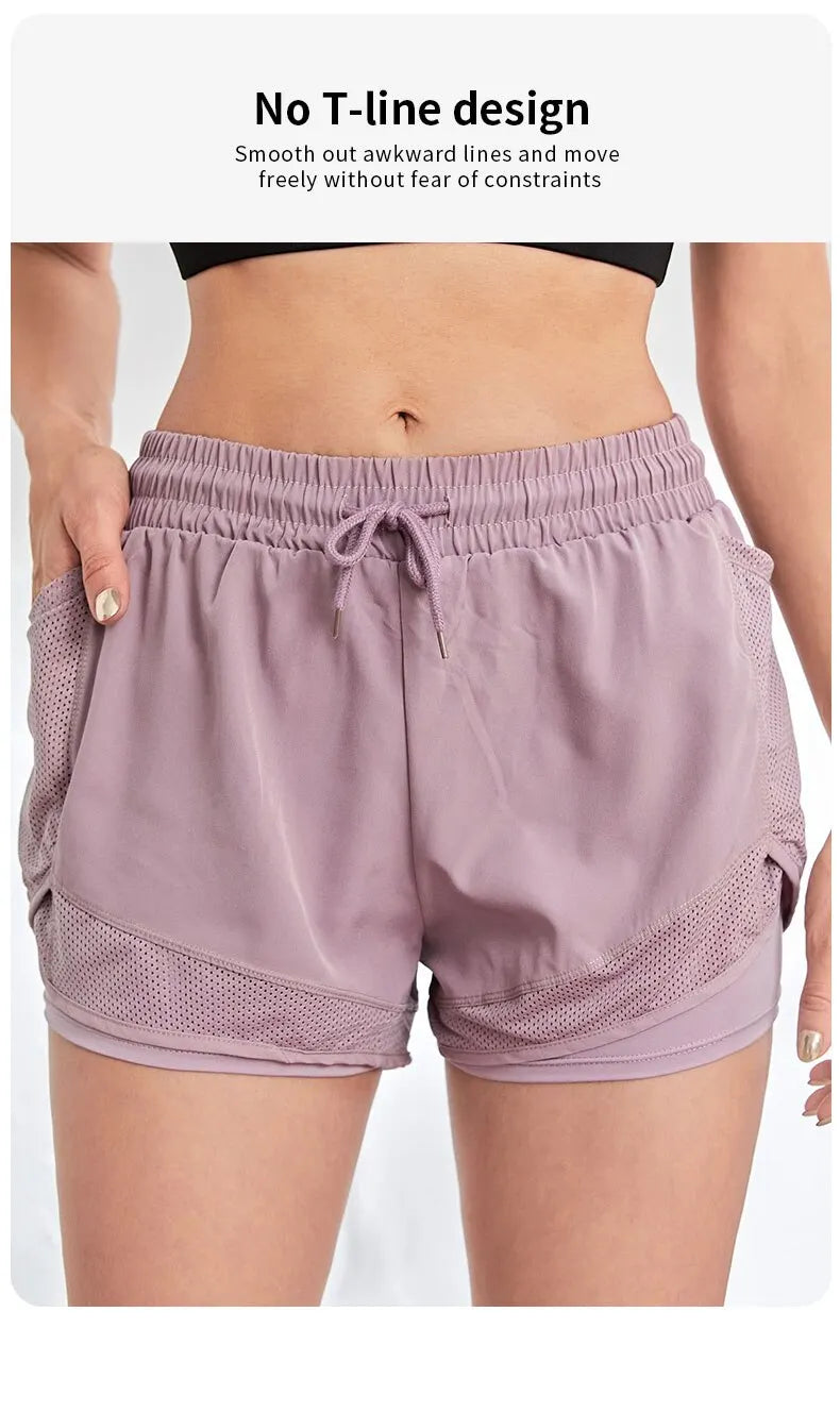 Person wearing a pair of light purple athletic shorts on a white background