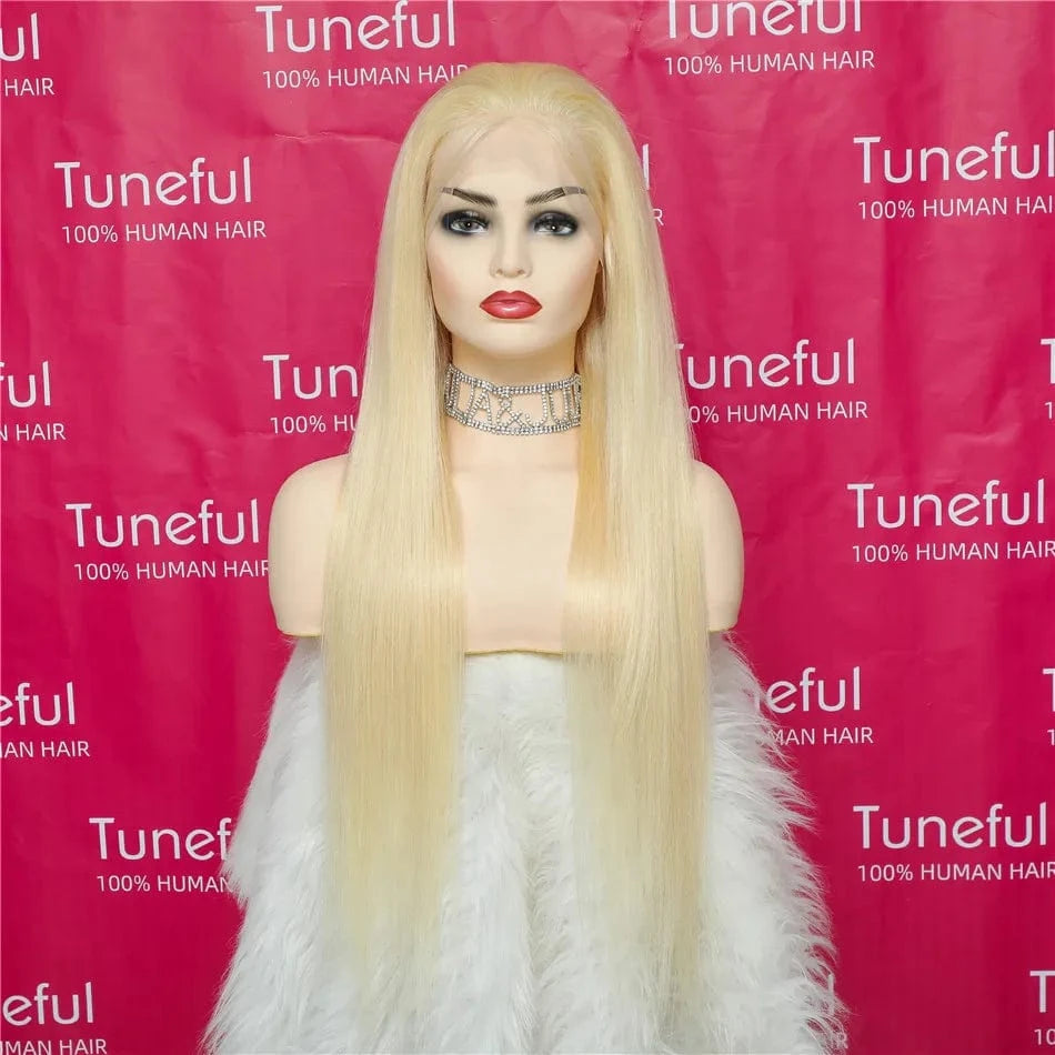 Blonde wig on a mannequin head with a pink background featuring the 'Tuneful' brand.