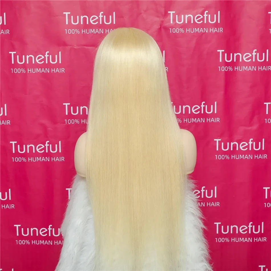 Blonde wig on a mannequin head with a pink background featuring 'Tuneful' branding.