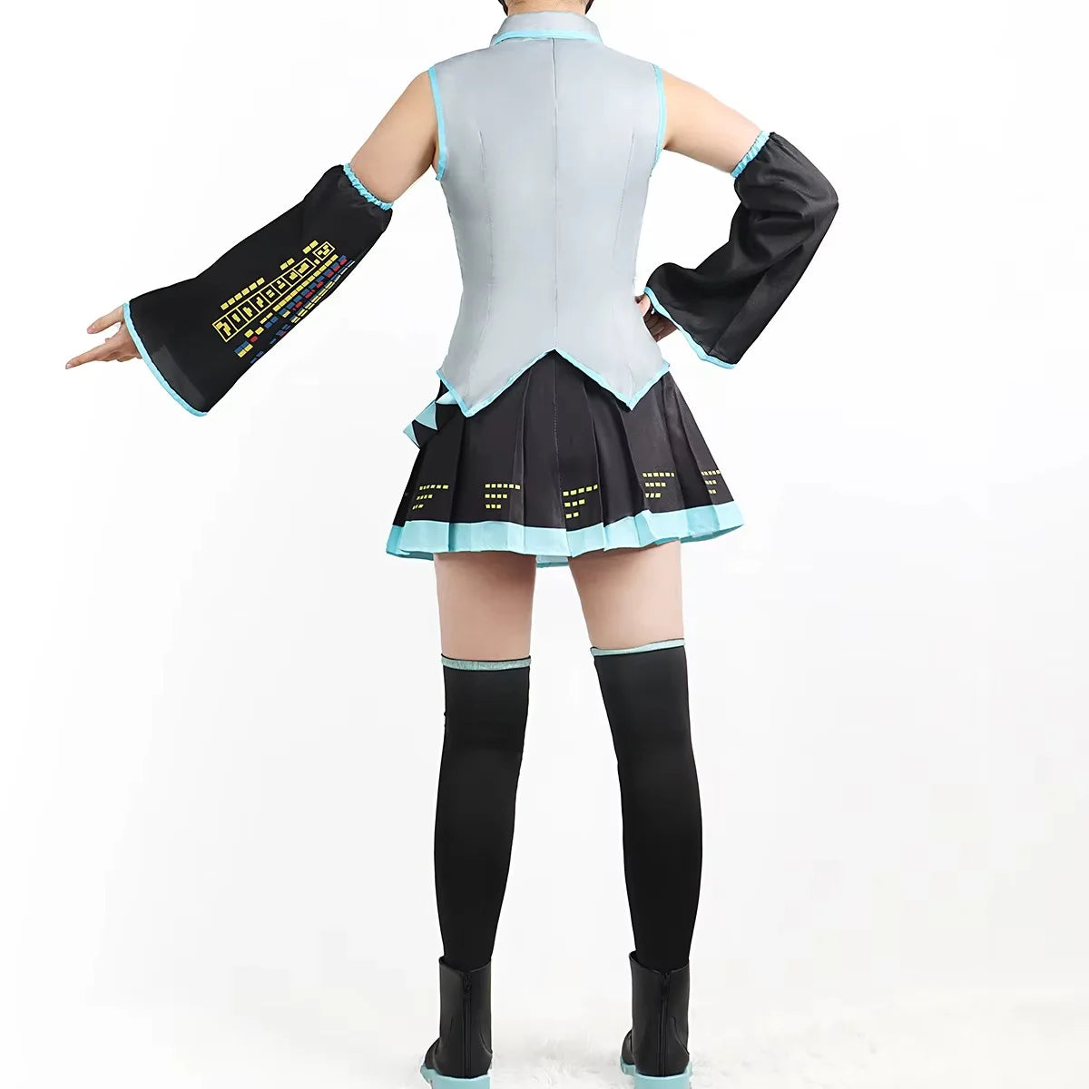 Person wearing a black and light blue outfit with long sleeves and a skirt on a white background