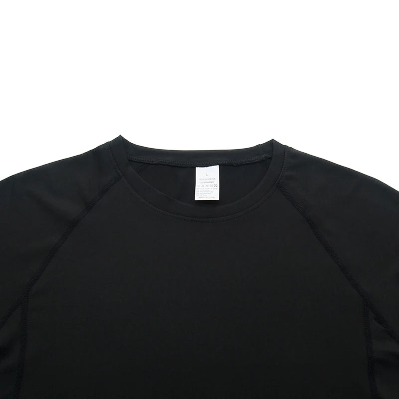 Black long-sleeve shirt with a white tag on a white background