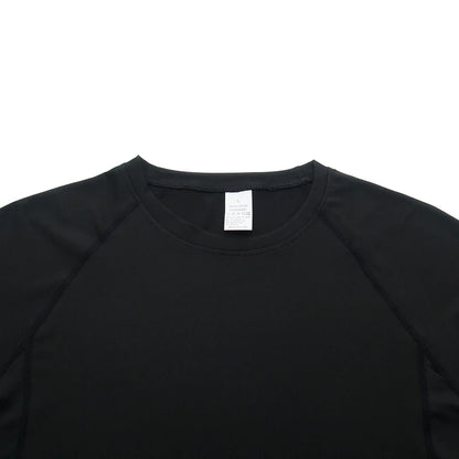 Black long-sleeve shirt with a white tag on a white background