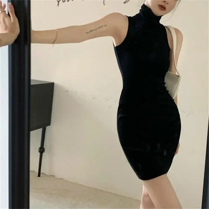 Person wearing a black sleeveless dress standing in front of a mirror.