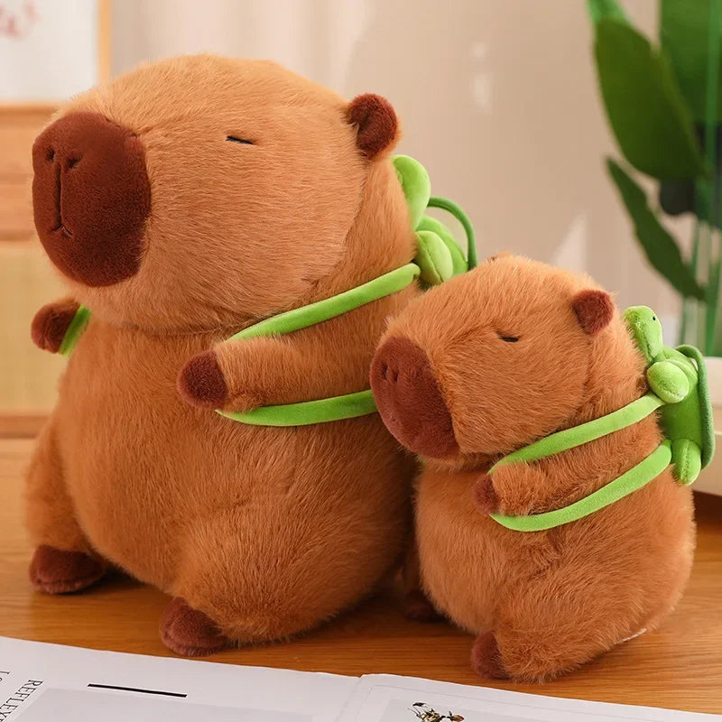 Two brown plush animals with green ribbons on a wooden surface.