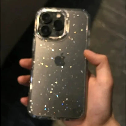 Hand holding a smartphone with a glittery case