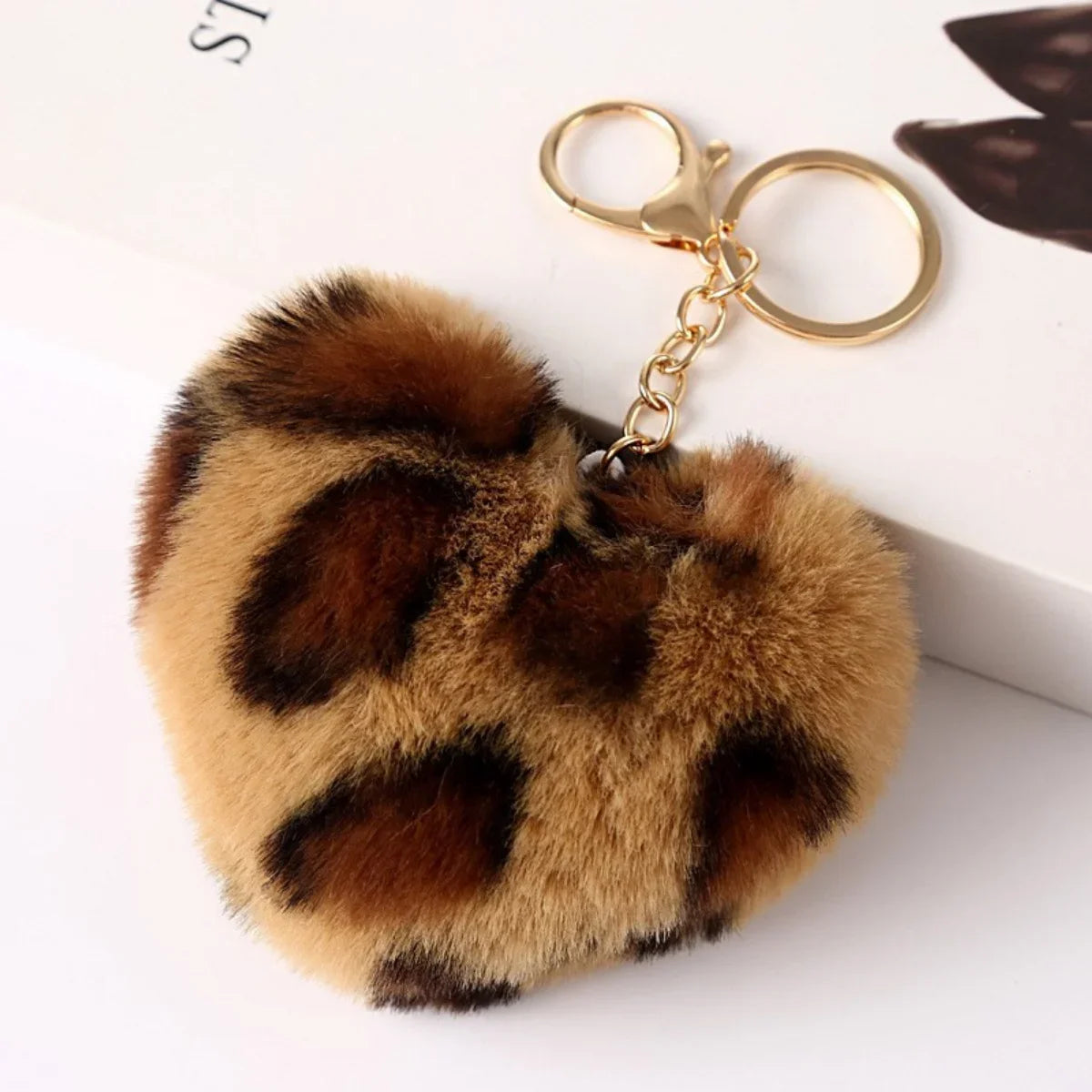 Leopard print fluffy keychain on a white background