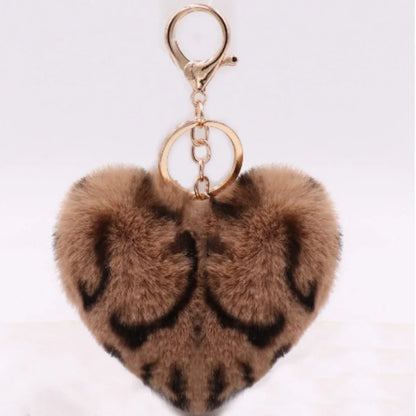 Heart-shaped fur keychain with gold ring on a white background