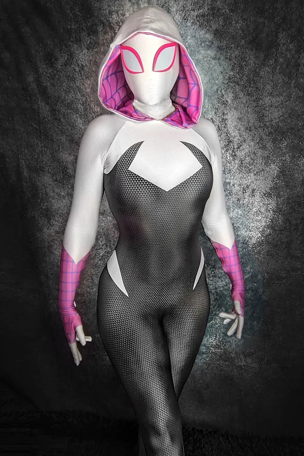 Person wearing a Spider-Gwen costume with a dark background