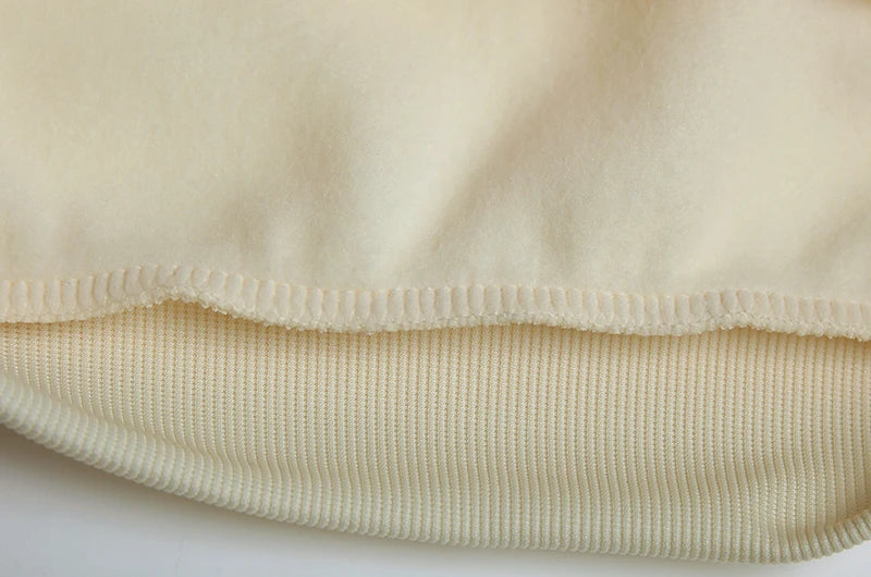 Close-up of beige fabric with a textured pattern on a white background