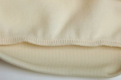 Close-up of beige fabric with a textured pattern on a white background