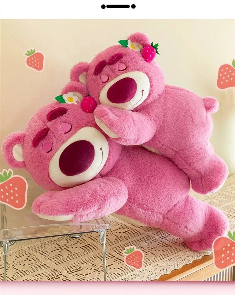 Two pink teddy bears hugging on a beige background with strawberry decorations.
