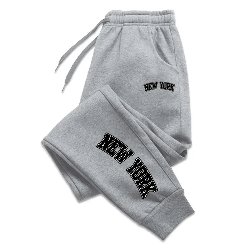 Unisex casual sports sweatpants in charcoal gray, slim jogger fit with elastic waistband and zip pockets
