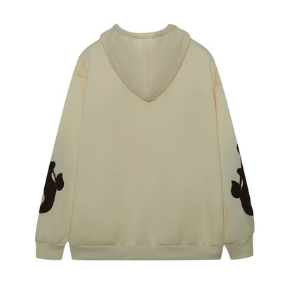 Beige hoodie with black designs on sleeves on a white background