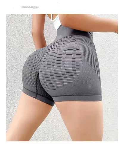 Gray athletic shorts worn by a person on a light gray background