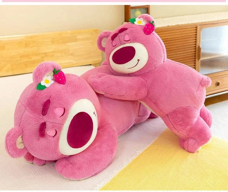 Two pink plush toys with flower and strawberry decorations on a light-colored floor.