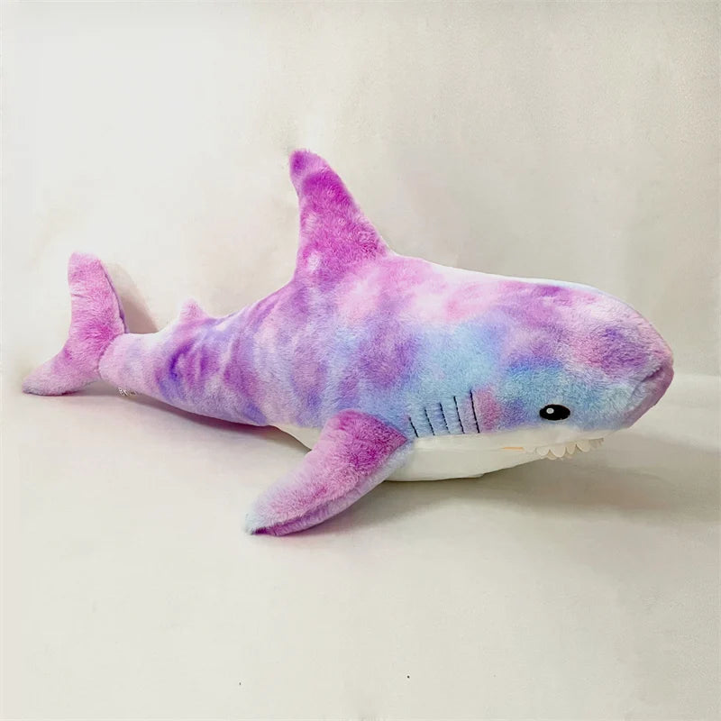 Plush shark toy with a tie-dye pattern on a white background
