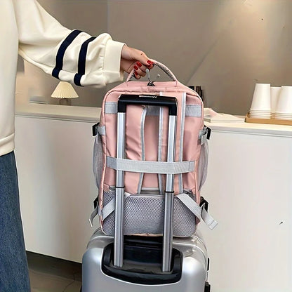 Pink backpack with wheels attached to a suitcase, held by a person.