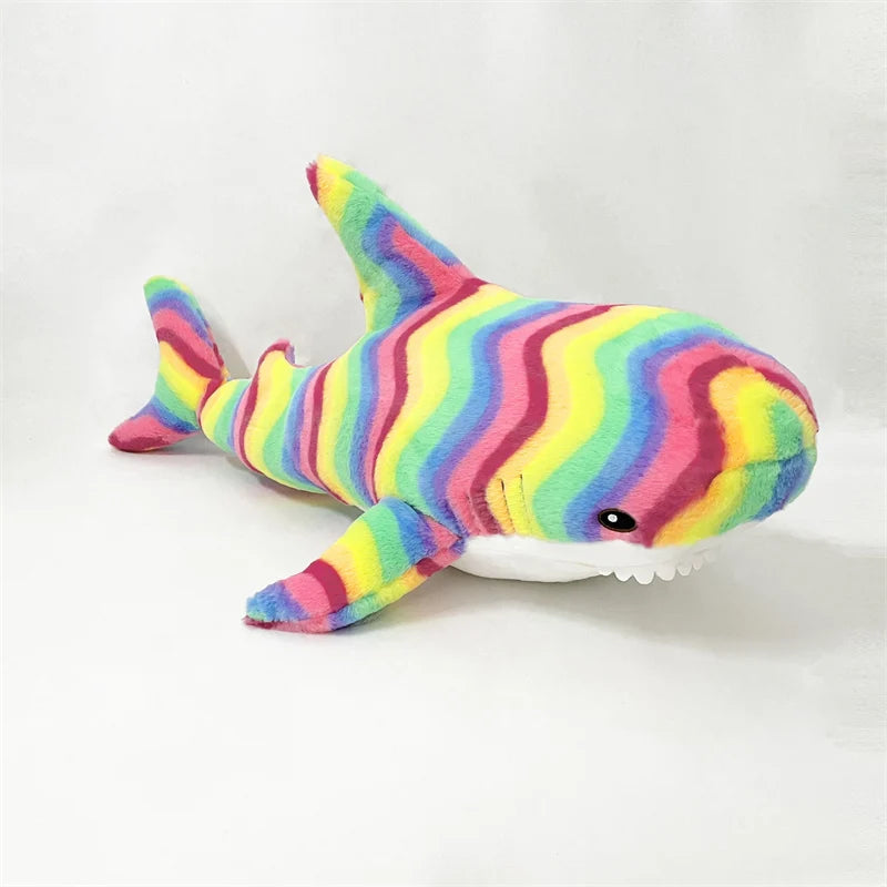 Colorful striped shark plush toy on a white background
