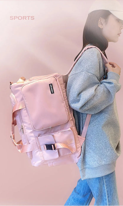 Person wearing a pink backpack with a soft pink background