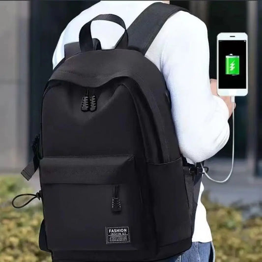 Person wearing a black backpack with a smartphone displaying a charging app.