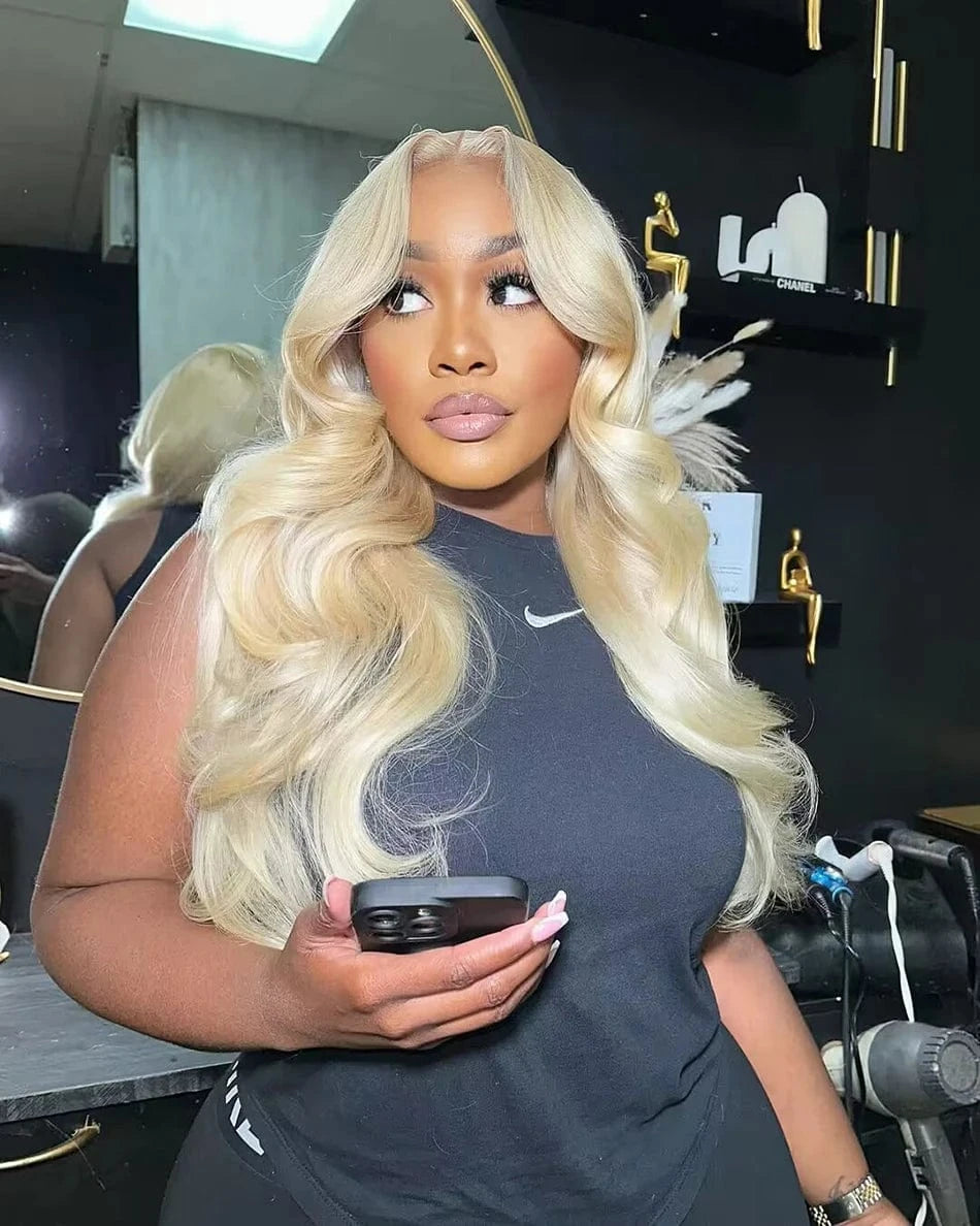 Woman with long blonde hair holding a phone in a salon setting
