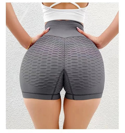 Person wearing gray high-waisted shorts on a white background