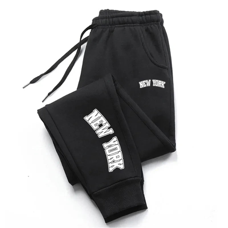 Unisex casual sports sweatpants in charcoal gray, slim jogger fit with elastic waistband and zip pockets