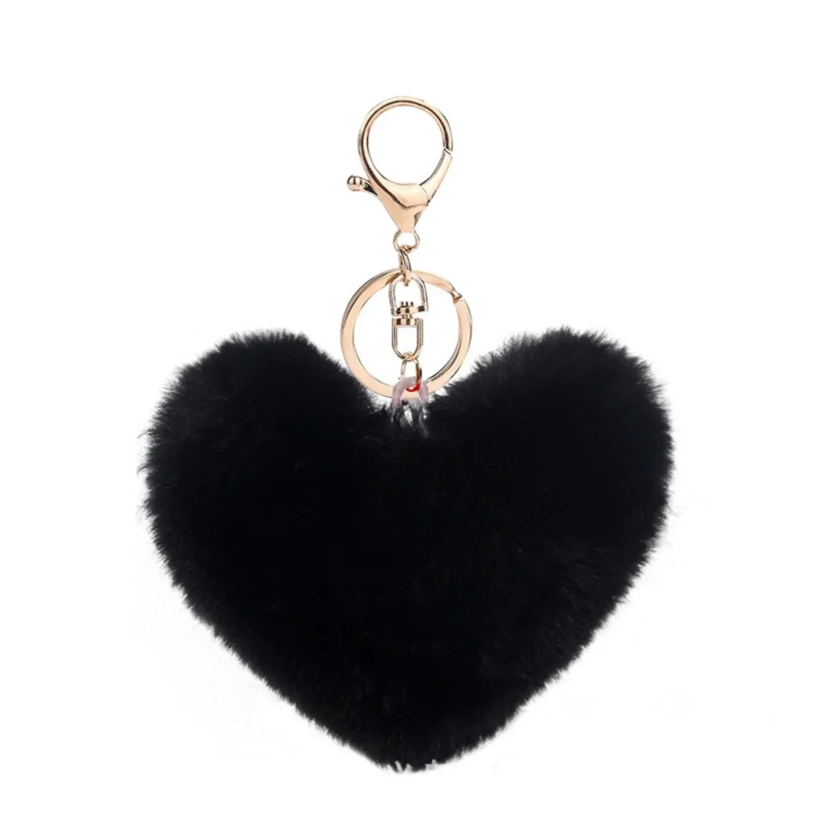 Black heart-shaped fluffy keychain with a gold chain on a white background