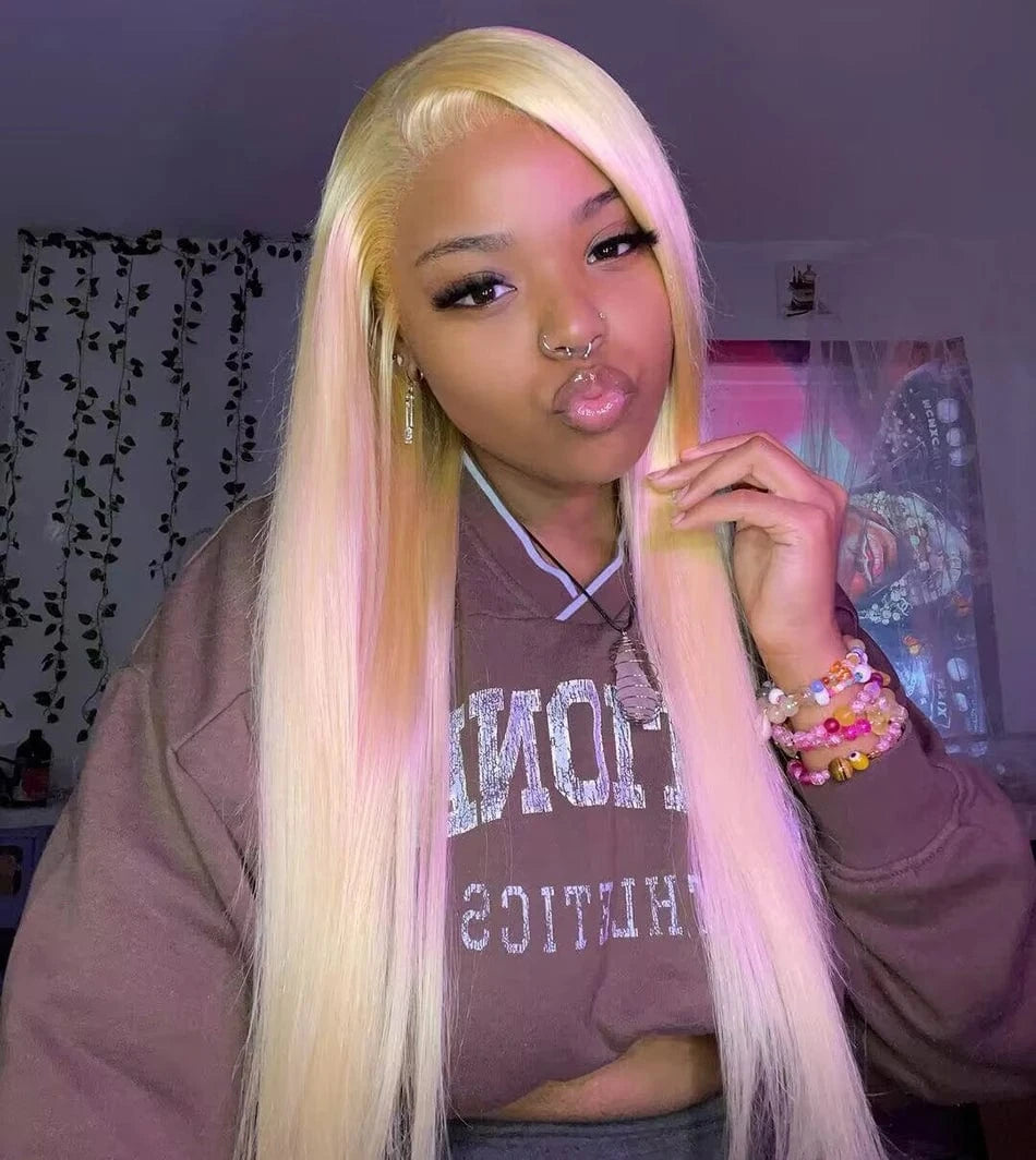 Person with long blonde hair posing indoors