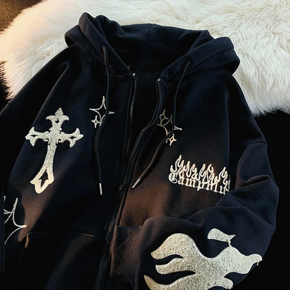 Black hoodie with white designs on a fluffy white surface
