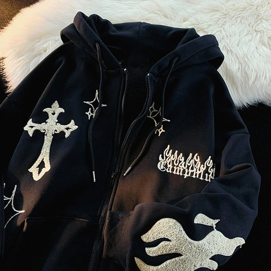 Black hoodie with white designs on a fluffy white surface