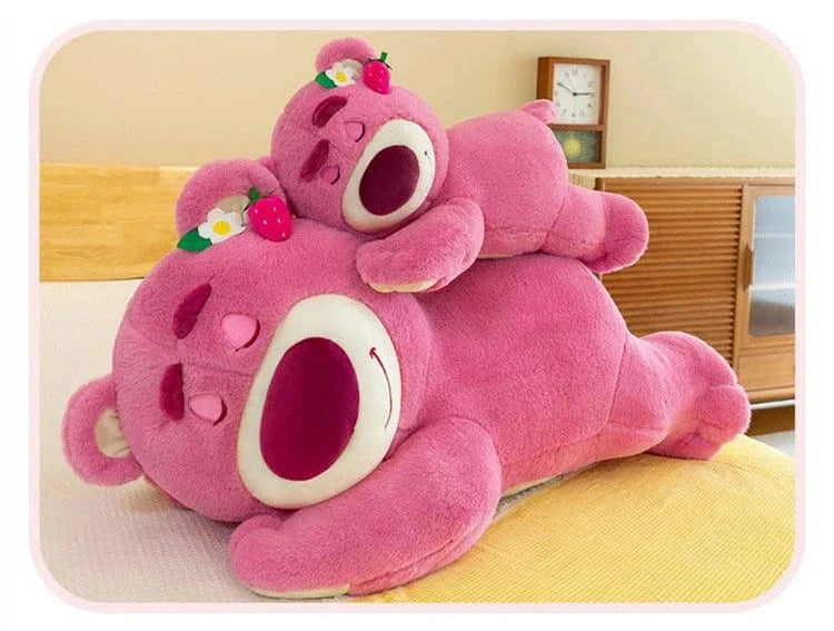 Pink plush toy resembling a cartoon character on a bed
