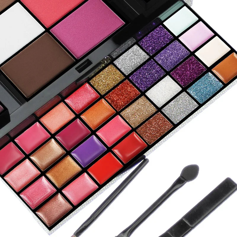 Makeup palette with various colors and two brushes on a white background
