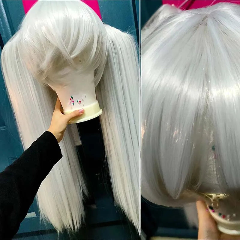 White wig on a mannequin head with a hand holding it steady against a blue background.
