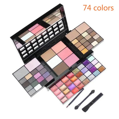 Makeup palette with multiple color swatches and two brushes on a white background, labeled '74 colors'.