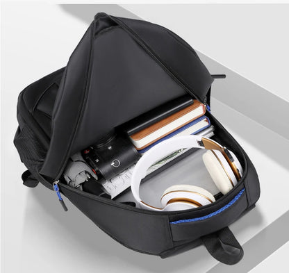 Black backpack with compartments containing electronic devices on a light gray background