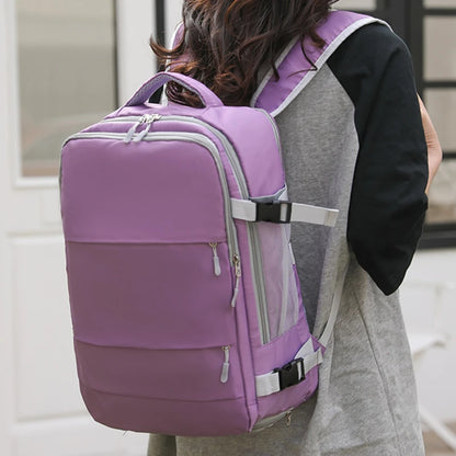 Person wearing a purple and gray backpack outdoors