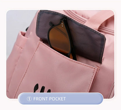 Pink backpack with sunglasses in a front pocket on a light gray background