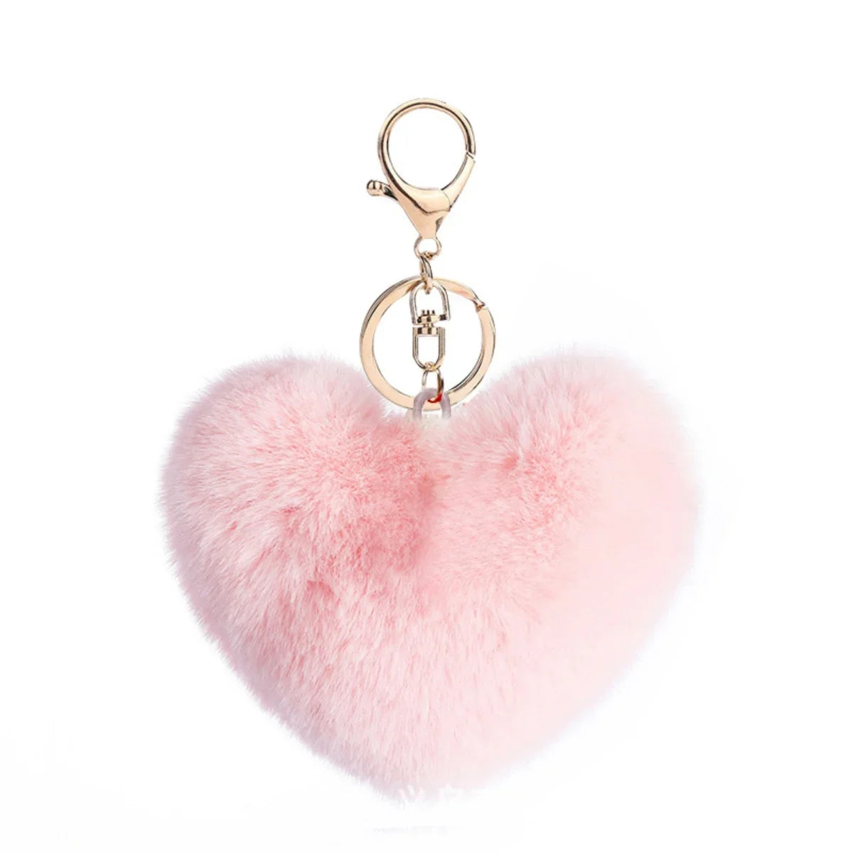 Pink heart-shaped fluffy keychain with a gold ring on a white background