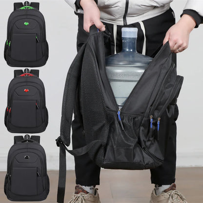 Person holding a black backpack with a water bottle, surrounded by four other black backpacks.