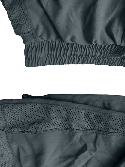 Close-up of a dark gray jacket with mesh detailing on a white background