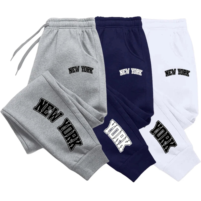 Unisex casual sports sweatpants in charcoal gray, slim jogger fit with elastic waistband and zip pockets