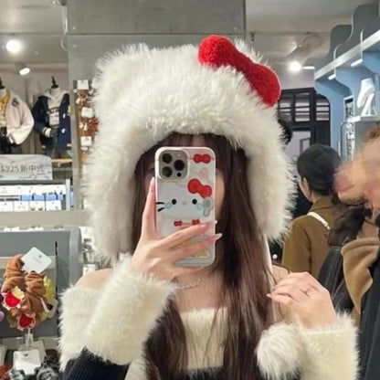 Person wearing a fluffy white hat with red accents in a store setting