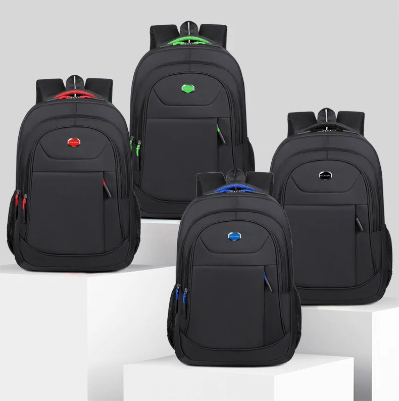 Four black backpacks with visible brand logos on a light gray background