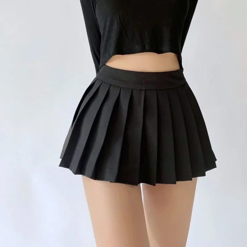 Black pleated skirt worn by a person on a white background