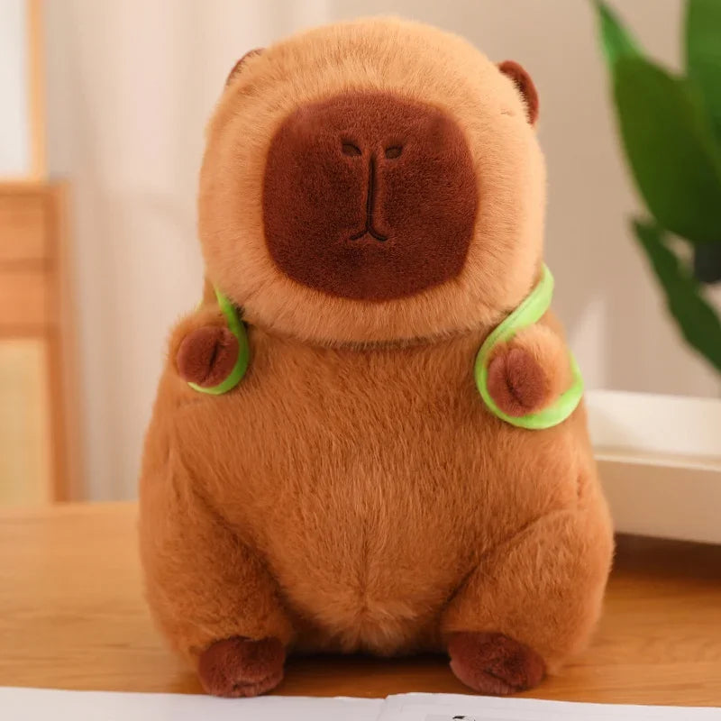 Brown teddy bear plush toy with green accents on a wooden surface.